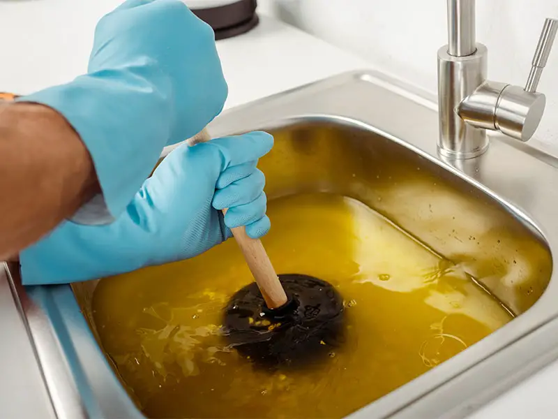 Plunger used on the kitchen sink to unclog the garbage disposal