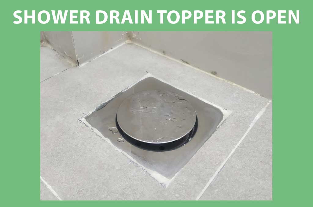 The shower drain topper is open