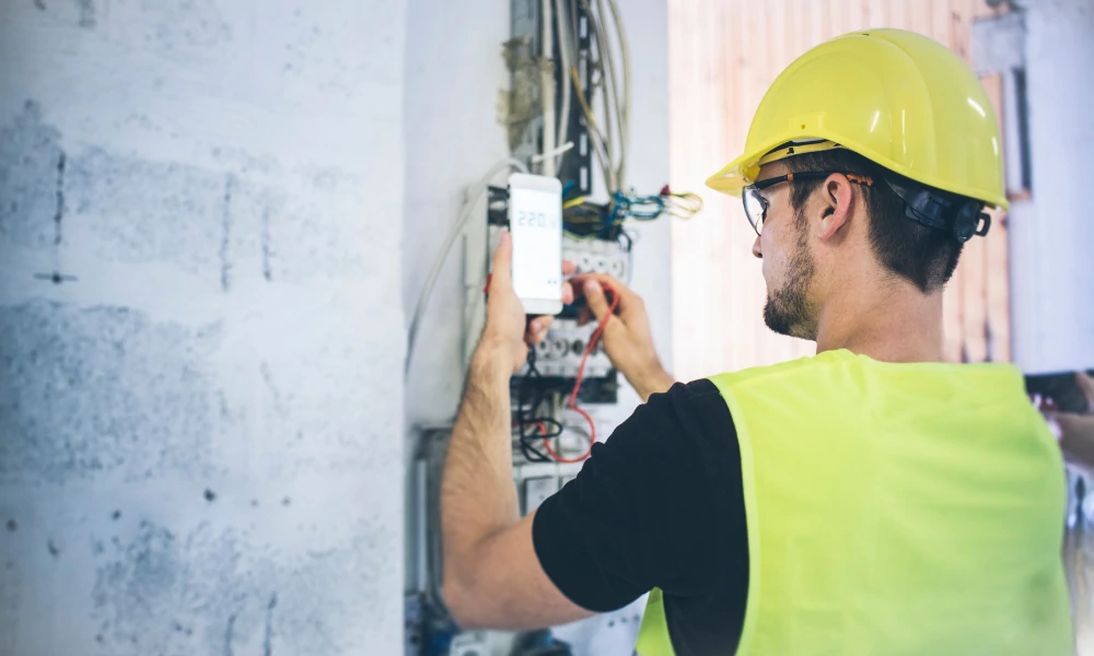 electrician checking the wires to install a garbage disposal