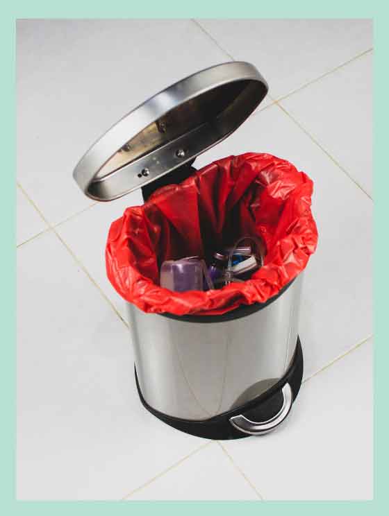 A pedal bin with a trash bag.